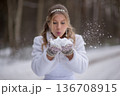 Bride Blowing Snow Into Winter Air 136708915