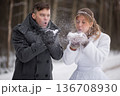 Winter Wedding Couple Blowing Snow Together Playfully 136708930