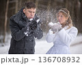 Playful Wedding Couple Blowing Snow Mid Air 136708932