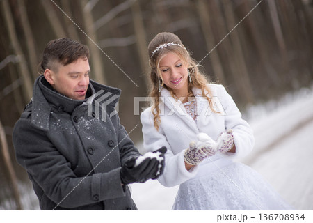 Bride and Groom Examining Snow In Gloves Bride and Groom Examining Snow In Gloves 136708934