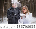 Winter Wedding Couple Blowing Snow Together Playfully 136708935