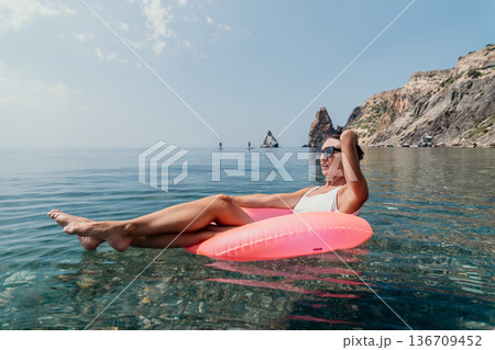 Relaxation vacation tropical water travel Floating woman rocky cliff shore summer enjoyment Relaxation vacation tropical water travel Floating woman rocky cliff shore summer enjoyment 136709452