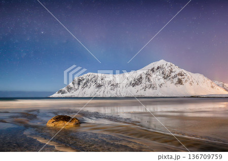 Captivating winter scenery on Skagsanden beach at night with starry sky. 136709759