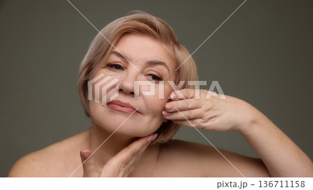 Mature woman supporting chin facial care concept. 136711158