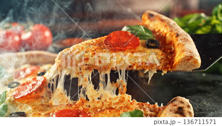 Closeup of a freshly baked pizza with melted cheese and golden crust in warm, appetizing light. Classic comfort food concept with rich texture and inviting presentation. 136711571