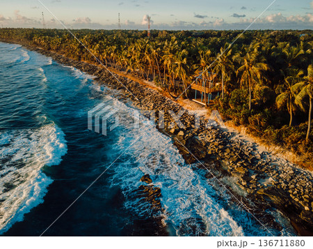 Ocean coastline at sunrise or sunset with waves, aerial view Ocean coastline at sunrise or sunset with waves, aerial view 136711880