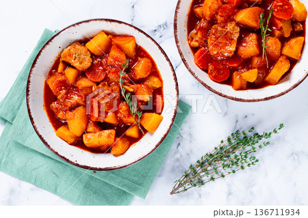 meat goulash with potatoes and carrots, sweet peppers, in a saucepan, top view, traditional Hungarian soup, homemade, no people, meat goulash with potatoes and carrots, sweet peppers, in a saucepan, top view, traditional Hungarian soup, homemade, no people, 136711934