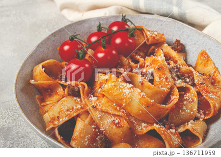 pappardelle pasta with bolognese sauce, topped with parmesan cheese and cherry branch, homemade, no people, 136711959