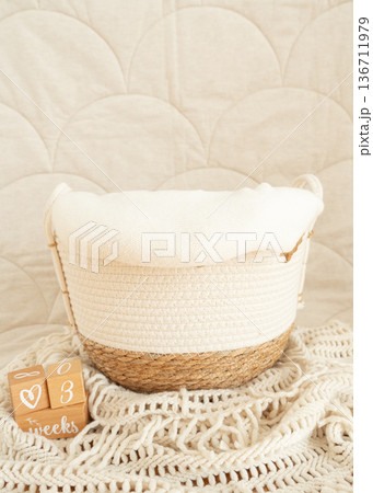 Minimal nursery setup with empty baby basket symbolizing preparation for newborn arrival. Ideal for maternity, parenting and baby product campaigns. 136711979