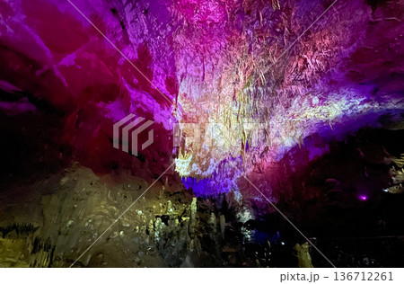 Crystalline cave with shimmering, multicolored stalactites and stalagmites Crystalline cave with shimmering, multicolored stalactites and stalagmites 136712261