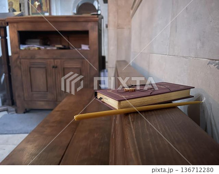 candle with new testament on the bench near the altar 136712280