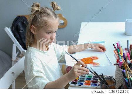 Blond young child painting at home. Close-up portrait of little girl indoor Blond young child painting at home. Close-up portrait of little girl indoor 136712398