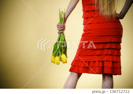 woman with yellow tulips bunch, back view woman with yellow tulips bunch, back view 136712722