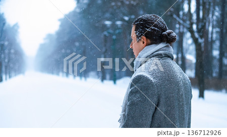 A lone man in a grey coat stands in a snowy park, gazing into the distance; a poignant image evoking deep depression, solitude, and the quiet journey of a lonely soul. High quality photo A lone man in a grey coat stands in a snowy park, gazing into the distance; a poignant image evoking deep depression, solitude, and the quiet journey of a lonely soul. High quality photo 136712926