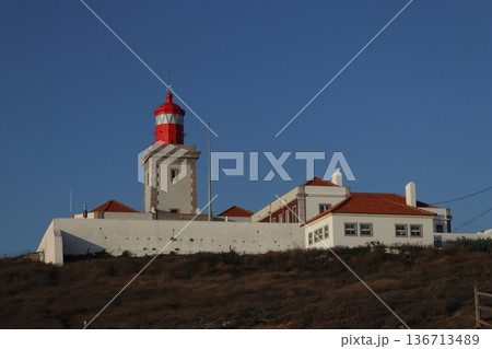 Red lighthouse tower and traditional white buildings at Cabo da Roca, Portugal. Red lighthouse tower and traditional white buildings at Cabo da Roca, Portugal. 136713489