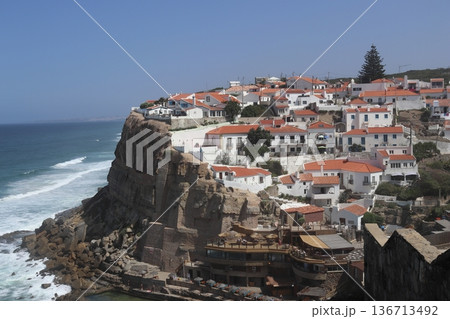 Traditional white village of Azenhas do Mar perched on a cliff, Portugal. Traditional white village of Azenhas do Mar perched on a cliff, Portugal. 136713492