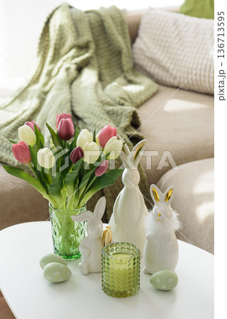 Living Room Decorated Easter Eggs with Bunny Figurines, Candles  and Tulips. Cozy Spring Holiday Arrangement 136713595