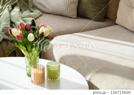 Living Room Decorated Spring Tulip Bouquet in Green Vase and Candles. Cozy Home Decor Arrangement 136713600