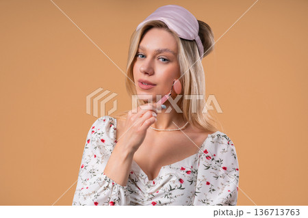 Charming Woman Doing Face Massage With Rose Quartz Stone Roller For Firmer 136713763