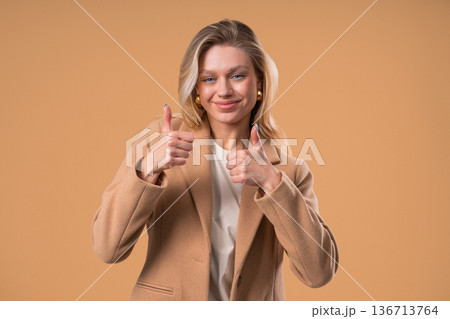 Positive Businesswoman With Hand Sign Likes, Thumbs Up Gesture. Lady on Beige Positive Businesswoman With Hand Sign Likes, Thumbs Up Gesture. Lady on Beige 136713764
