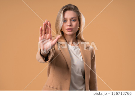 Blonde Businesswoman With Palm In Stop Gesture, Clear Assertive Body Language Blonde Businesswoman With Palm In Stop Gesture, Clear Assertive Body Language 136713766