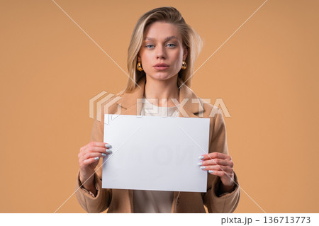 Young Serious Businesswoman With Blank Billboard In Hands. Copy space, Mockup Young Serious Businesswoman With Blank Billboard In Hands. Copy space, Mockup 136713773