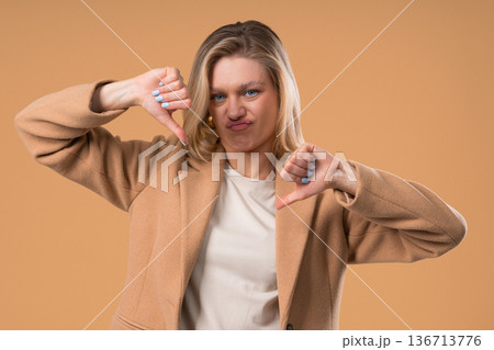Businesswoman With Sign Of Dislike. Grimacing Student Lady Showing Thumbs-Down Businesswoman With Sign Of Dislike. Grimacing Student Lady Showing Thumbs-Down 136713776