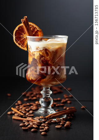 Iced coffee with cream on a black background. 136713785