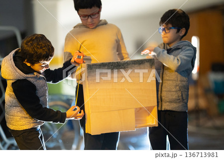 Children learning carpentry activity measuring wooden box Children learning carpentry activity measuring wooden box 136713981