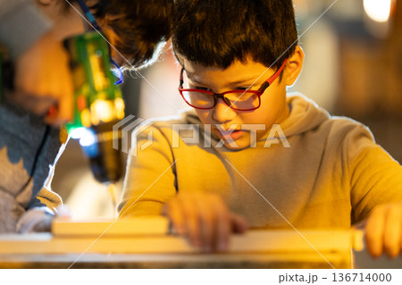 Young boy learning woodworking skills with adult Young boy learning woodworking skills with adult 136714000