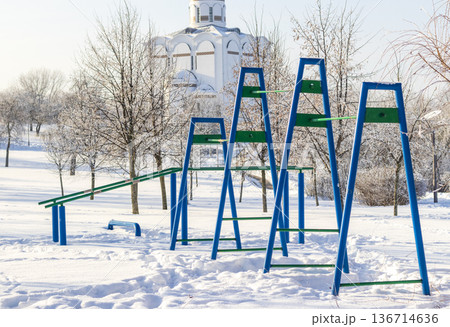 Set of outdoor fitness equipment designed for calisthenics and street workouts captured during winter month. All covered with a snow Set of outdoor fitness equipment designed for calisthenics and street workouts captured during winter month. All covered with a snow 136714636