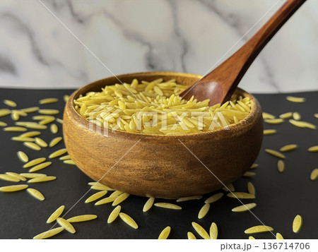 Orzo Pasta in Wooden Bowl on Dark Background 136714706