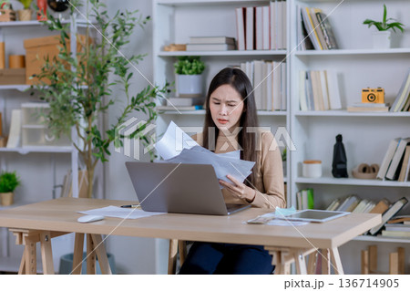 Businesswoman angry throwing papers over the herself in office Businesswoman angry throwing papers over the herself in office 136714905