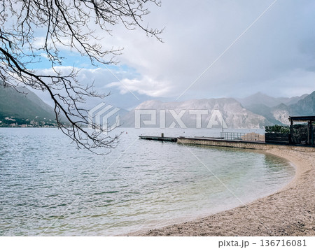 Beach with gentle waves. Serene coastal scene with pier and mountain view 136716081