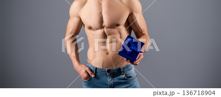 Muscular Torso. Sexy Man with gift. Athletic Gay Posing Naked holding Gift. Nude guy. Gay model. Male muscular body. Boy with present gift. Topless boyfriend ready for Christmas, Easter or birthday. 136718904