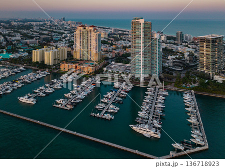 Miami Beach marina with yachts and sailboats. Miami marina and turquoise ocean. Miami seascape aerial view on south beach shore. Luxury cruise ship in Miami harbor. Skyline view of Miamis cityscapes. Miami Beach marina with yachts and sailboats. Miami marina and turquoise ocean. Miami seascape aerial view on south beach shore. Luxury cruise ship in Miami harbor. Skyline view of Miamis cityscapes. 136718923