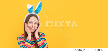 she is so cute. childhood happiness. child in rabbit costume. time for fun. kid wearing funny ears. Easter child horizontal poster. Web banner header, copy space. 136718925