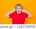 Child hold lemon in studio. Studio portrait of cute kid boy with lemon isolated on yellow. 136718958
