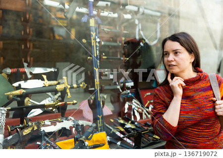 Woman tourist chooses souvenirs traditional for city of Toledo. Spain 136719072