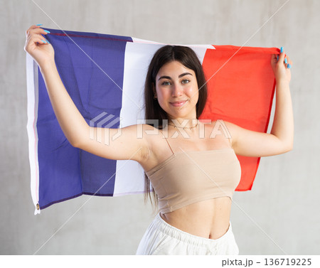 Young woman with flag of France posing in studio 136719225