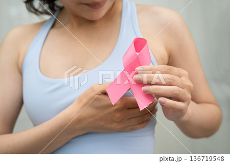 Breast cancer, pink ribbon at Asian senior lady for supporting awareness, symbol of World Breast Cancer Day. Breast cancer, pink ribbon at Asian senior lady for supporting awareness, symbol of World Breast Cancer Day. 136719548