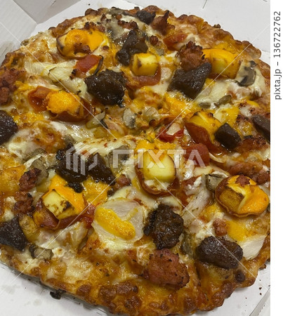 A delicious pizza with a golden crust, melted cheese, and savory toppings. Perfect for food-related designs, menus, or Italian-themed projects, capturing the essence of a classic comfort dish. 136722762