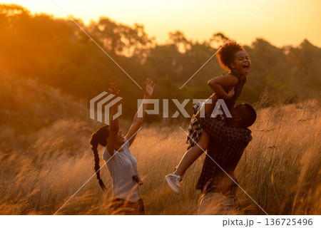 Happy African family father and child daughter travel and running on meadow Happy African family father and child daughter travel and running on meadow 136725496