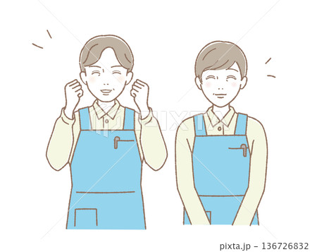 エプロン姿で笑顔の中高年男女ペア ガッツポーズと微笑み 介護・医療・福祉 136726832