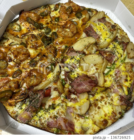A delicious pizza with a golden crust, melted cheese, and savory toppings. Perfect for food-related designs, menus, or Italian-themed projects, capturing the essence of a classic comfort dish. 136726925