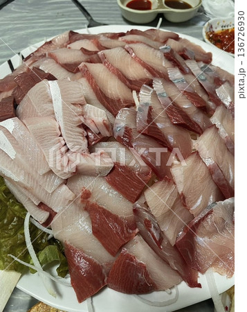 Fresh and delicate sashimi slices, beautifully presented with vibrant colors and perfect cuts. This traditional Japanese delicacy highlights the pure flavors of premium seafood. 136726930
