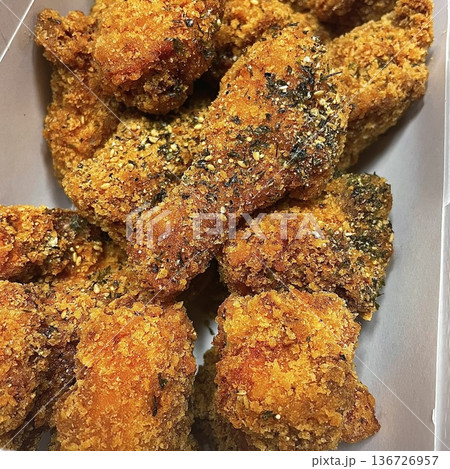 Crispy Korean fried chicken, perfectly glazed with a sweet and spicy sauce. Ideal for food photography and menus, showcasing the irresistible crunch and flavor of this beloved dish. 136726957