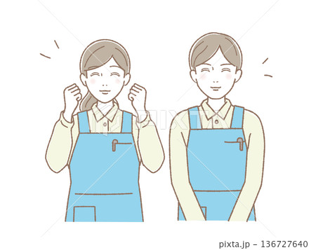 エプロン姿で笑顔の若い男女ペア ガッツポーズと微笑み 介護・家事代行・医療スタッフ 136727640