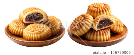 Traditional Maamoul cookies, one halved showing date and nut filling, isolated on white background, concept of Arabic desserts Traditional Maamoul cookies, one halved showing date and nut filling, isolated on white background, concept of Arabic desserts 136729009