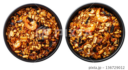 Stir-fried shrimp Pad Thai with crushed peanuts and rice noodles, isolated on white background, concept of Thai cuisine 136729012